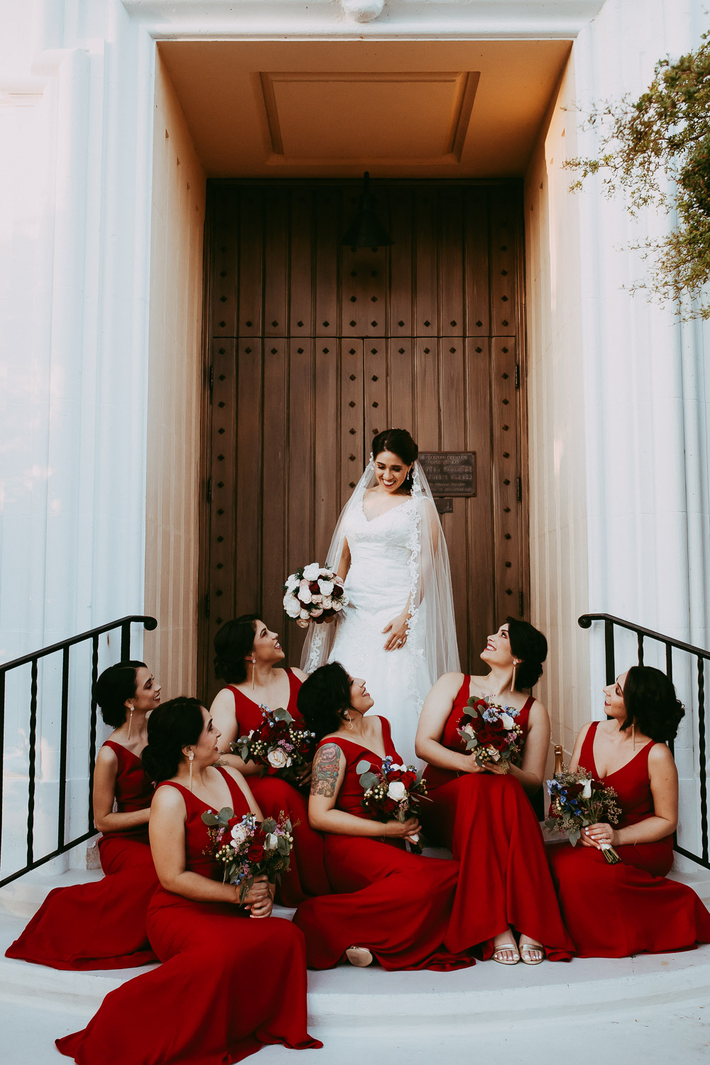 bridesmaids with bride in red dresses 