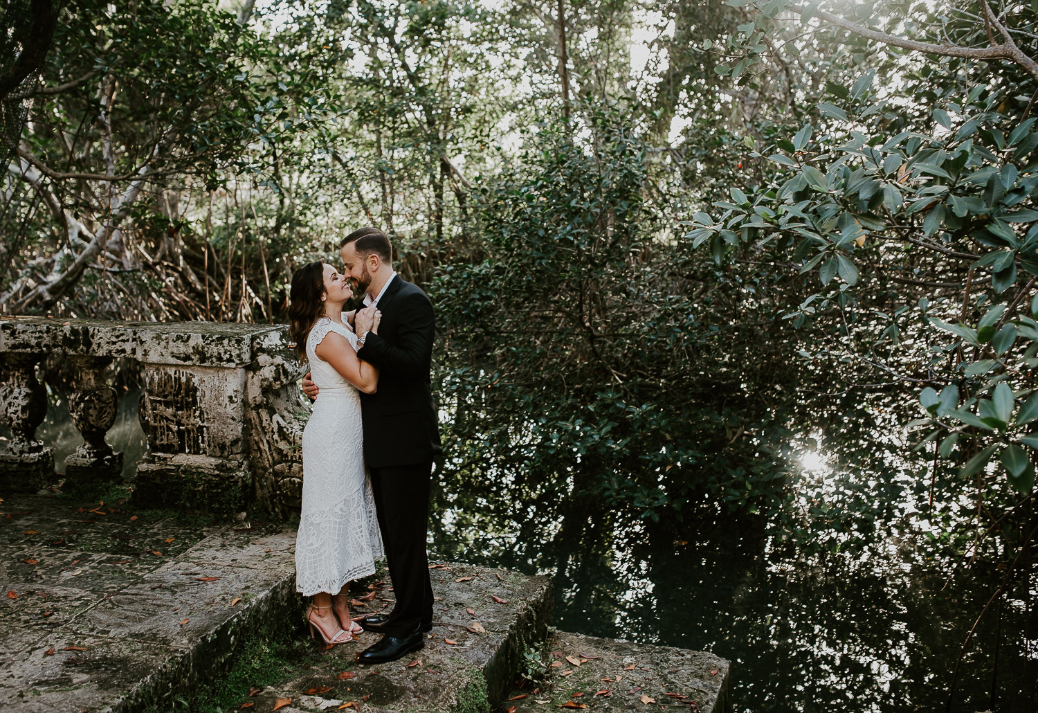 bride and groom surrounded by greenery 
