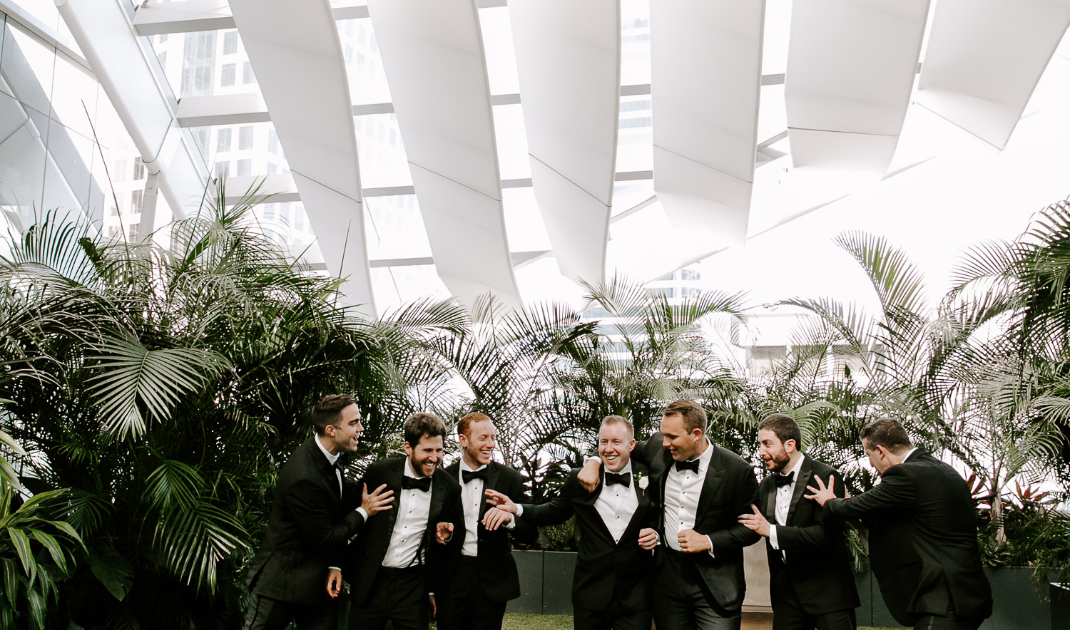 groomsmen laughing and pushing each other 