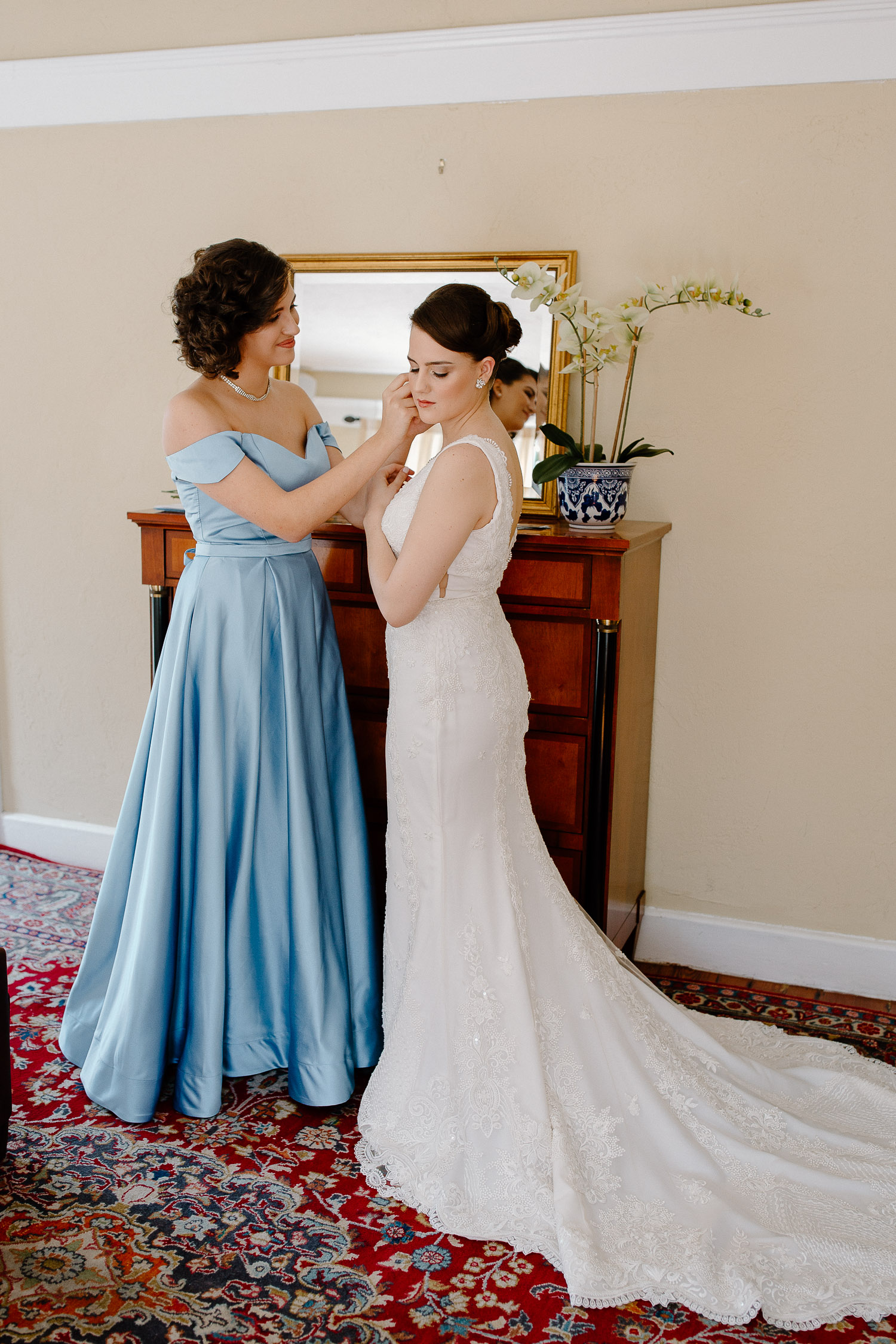 bride with sister wearing a blue dress 