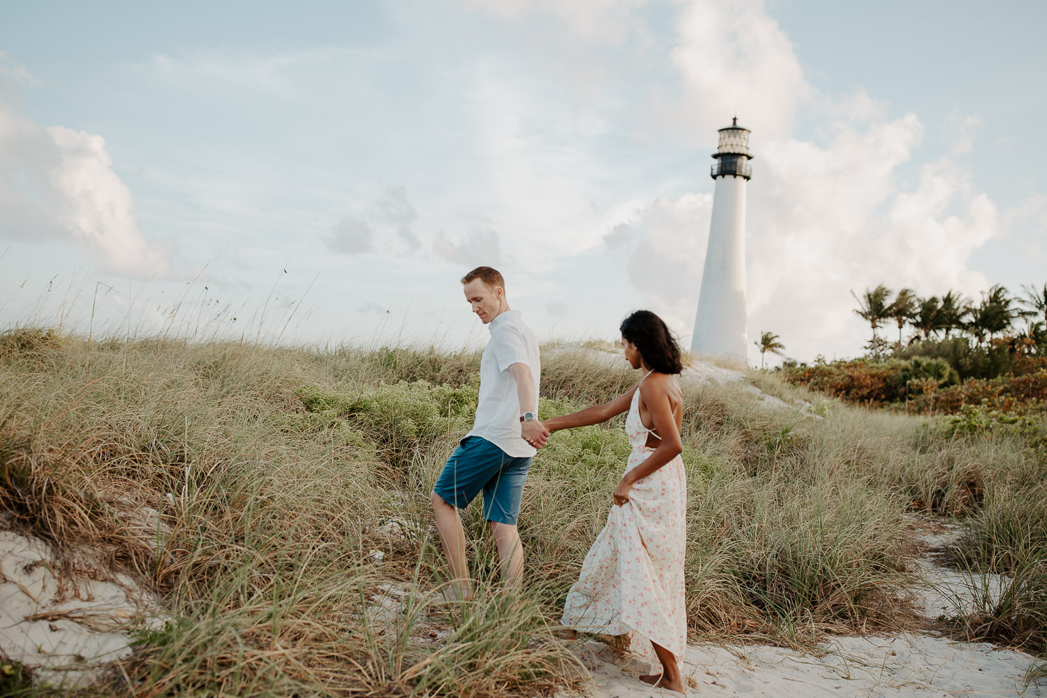 couple walking along the lighthouse 