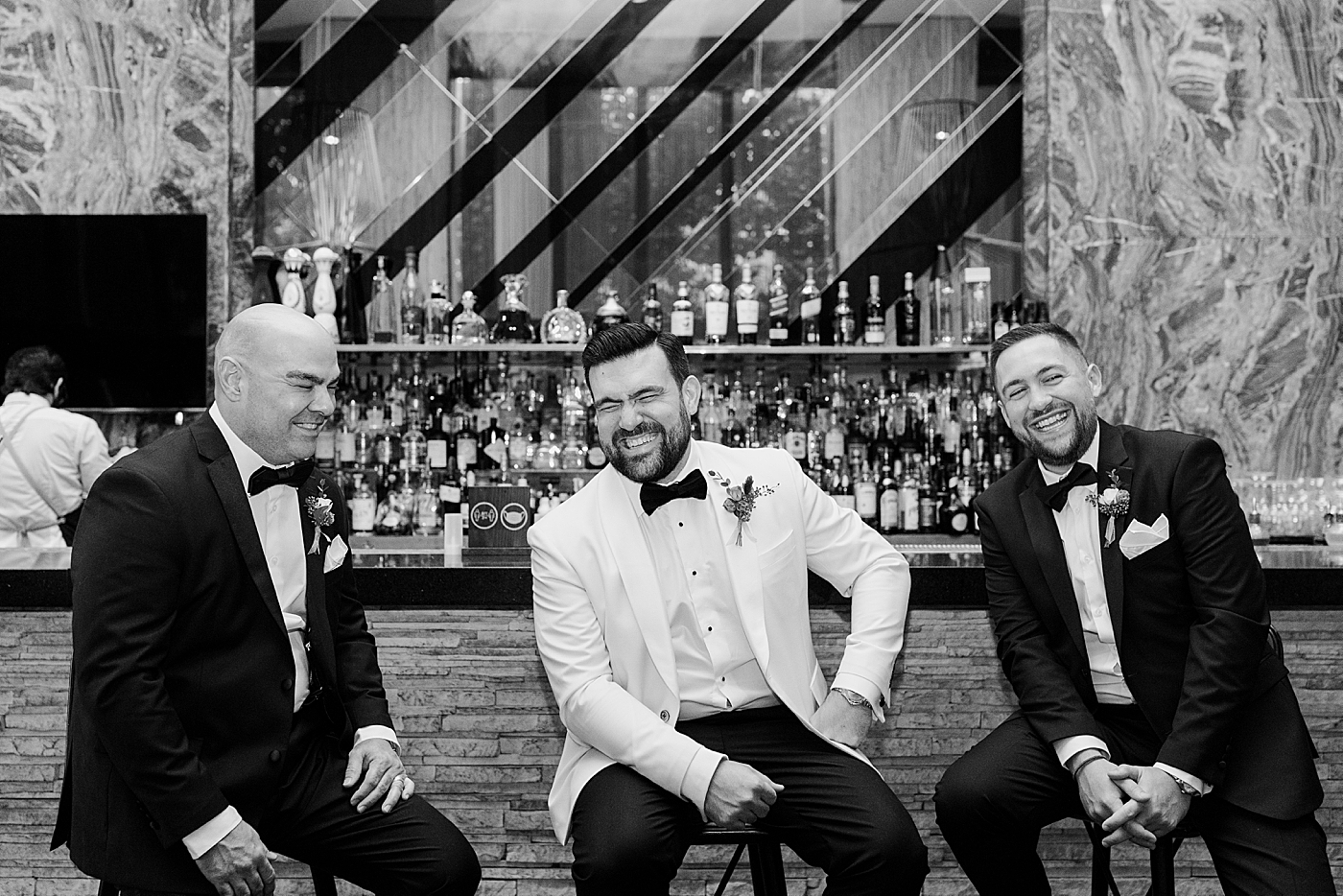 B&W portrait of Groom and Groomsmen sitting at the bar Modern Elegant Wedding at The W South Beach captured by South Florida Wedding Photographer Erika Tuesta Photography