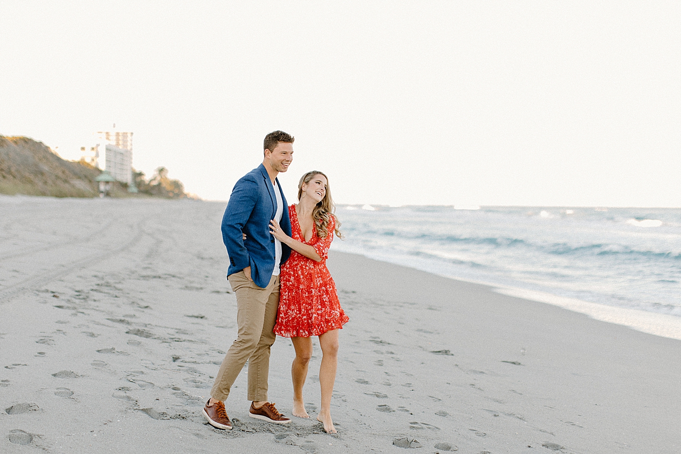 Candid portrait of couple holding each other on the beach Red Reef Park Engagement Photography captured by South Florida Engagement Photographer