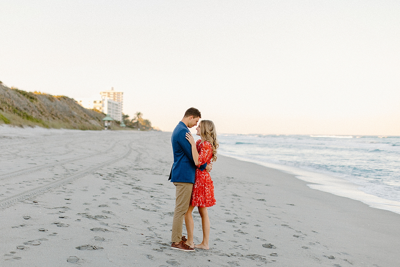 Couple holding each other on the beach Red Reef Park Engagement Photography captured by South Florida Engagement Photographer
