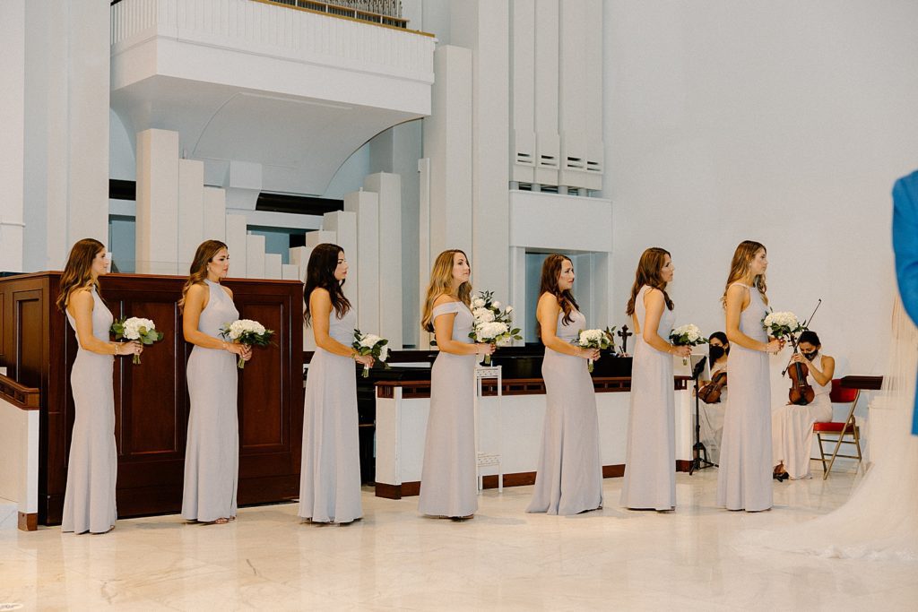 Bridesmaids lined up in Sanctuary with white bouquet during Ceremony
