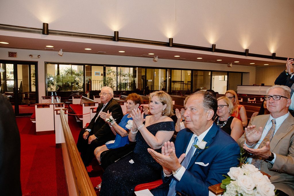 Guests clapping after Bride and Groom kiss