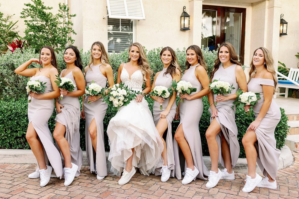 Bride and Bridesmaids showing off leg and casual sneakers