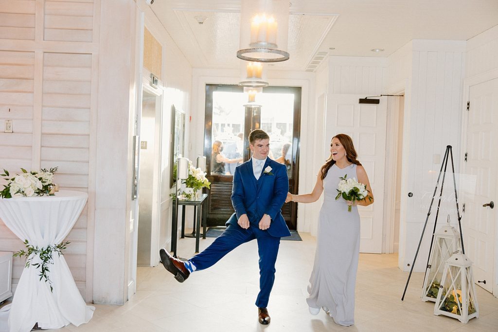 Groom and Bridesmaid entering Reception with fun poses