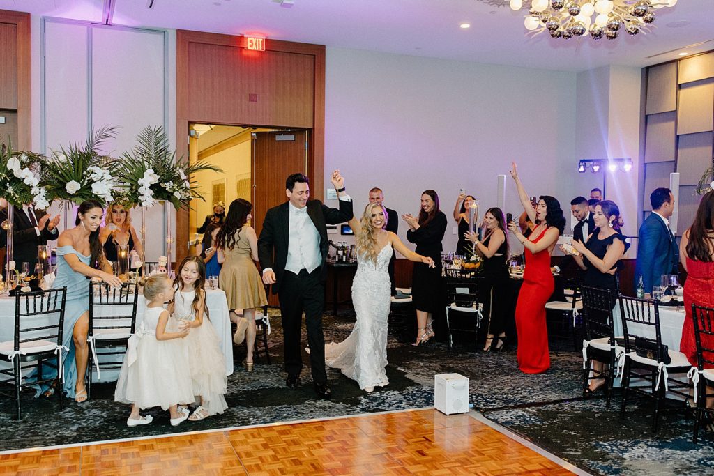 Bride and Groom entering Reception with hands raised up