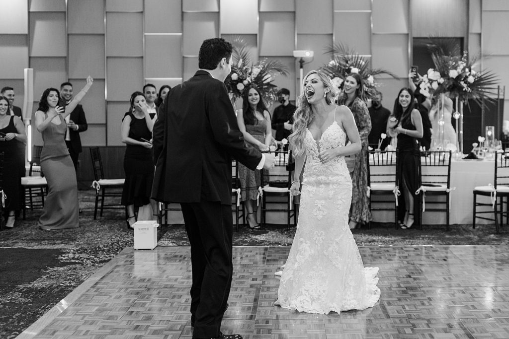 B&W Groom and Groom reacting after first dance