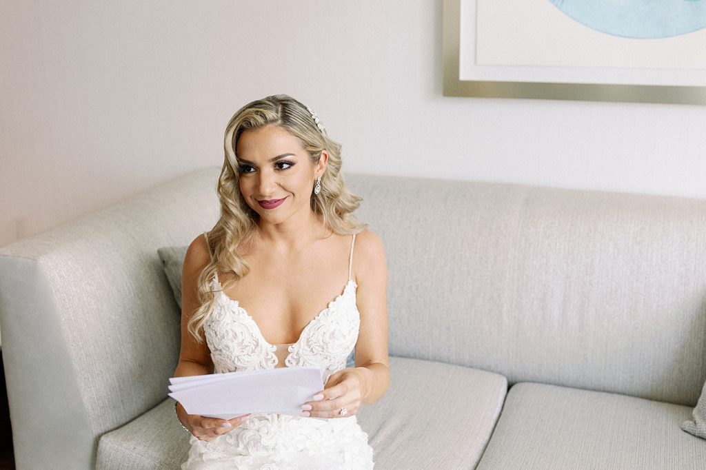 Bride holding letter on couch