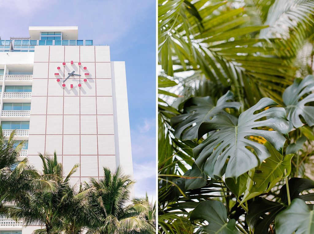 Detail shot of hotel with classic clock on it and green palm leafs