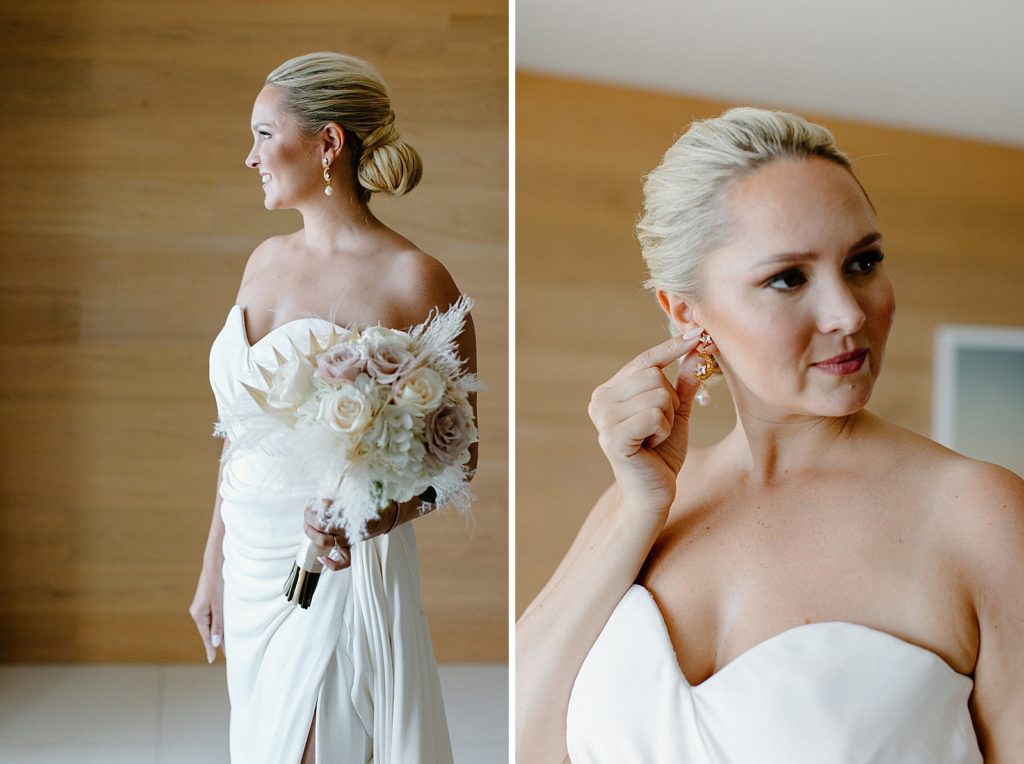 Portrait of Bride with bouquet in hotel room and adjusting earring