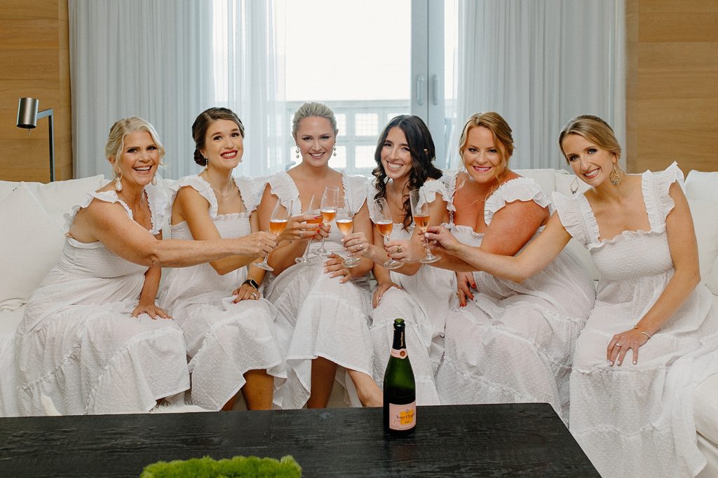Bride with Bridemaids cheering before getting ready with Champaign