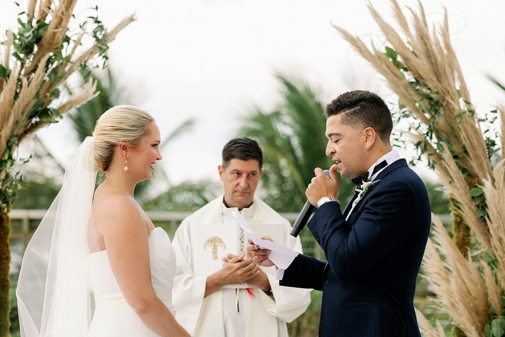 Groom giving vows during outdoor Ceremony