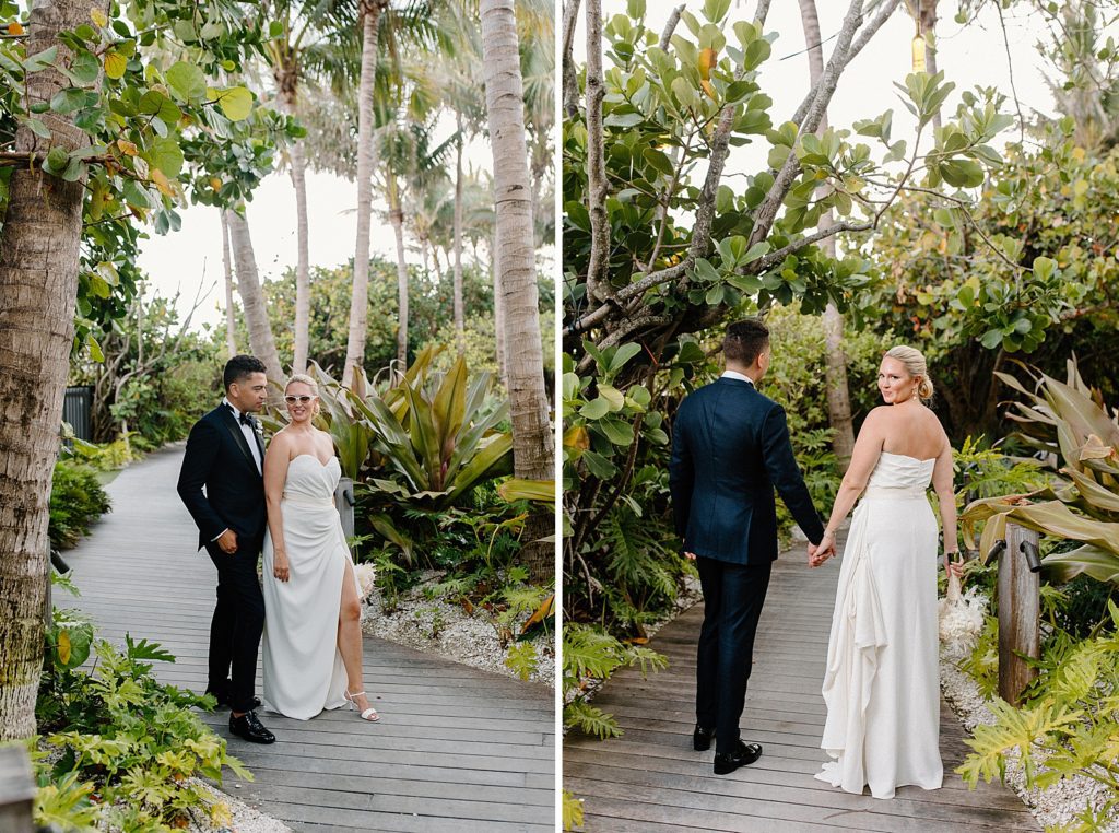 Bride and groom walking on boardwalk in green botanical area