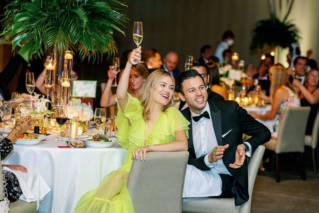 Guests raising a glass for toast at Reception