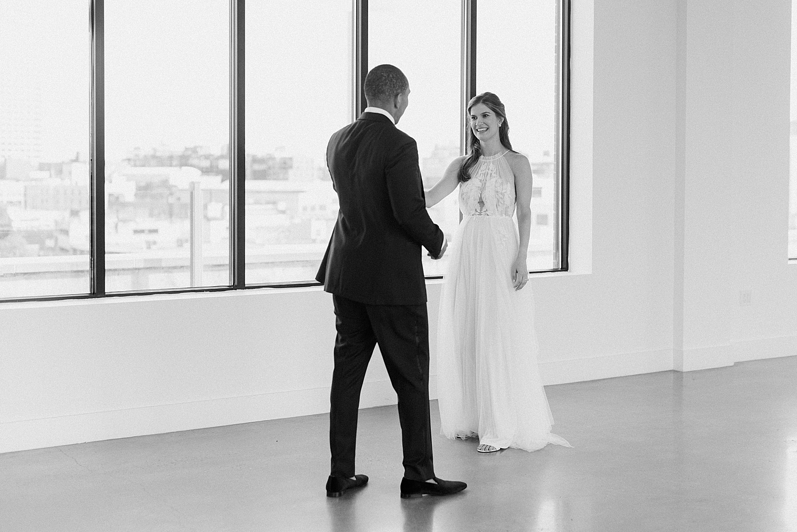 B&W Bride and Groom candid extending their hands to each other, Long Island NY wedding photographer