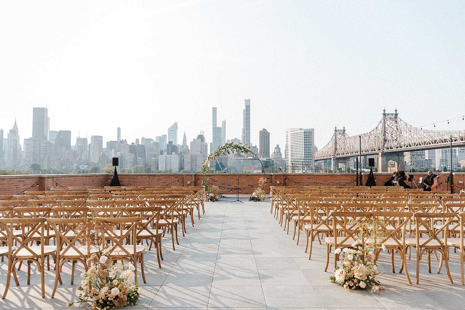 Detail shot of outdoor LIC Ceremony area with circular alter piece and view of Chrysler building and Queensboro bridge