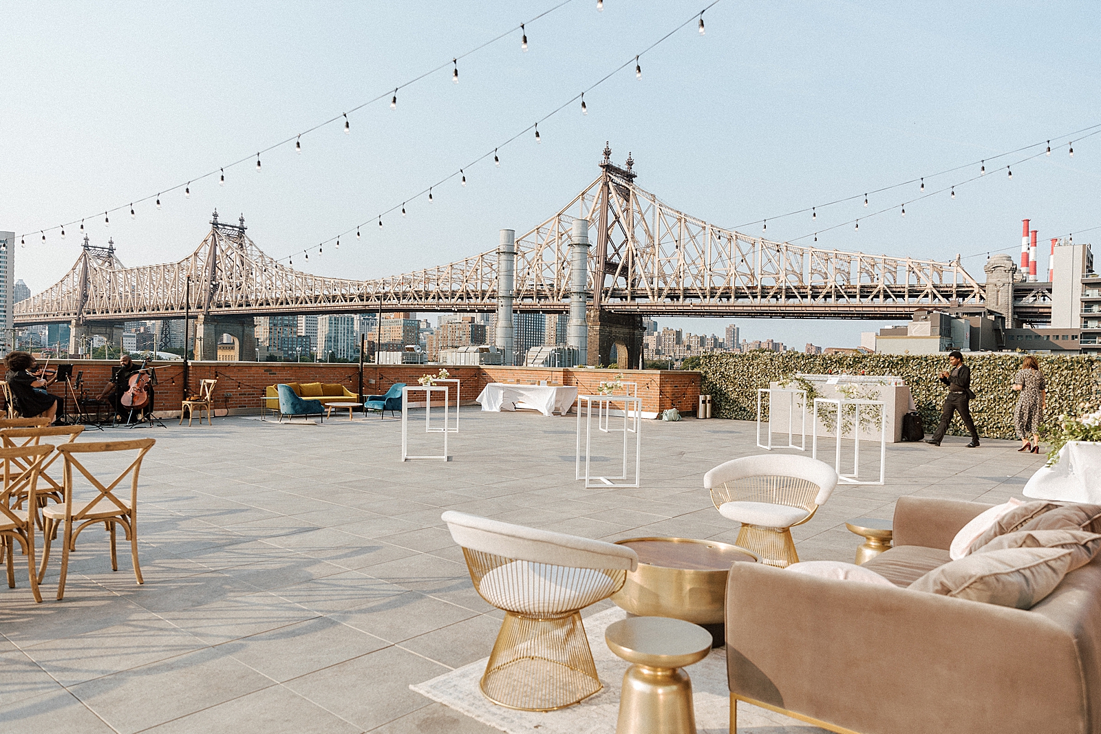 Detail shot of cocktail hour area with string musicians and queensboro bridge