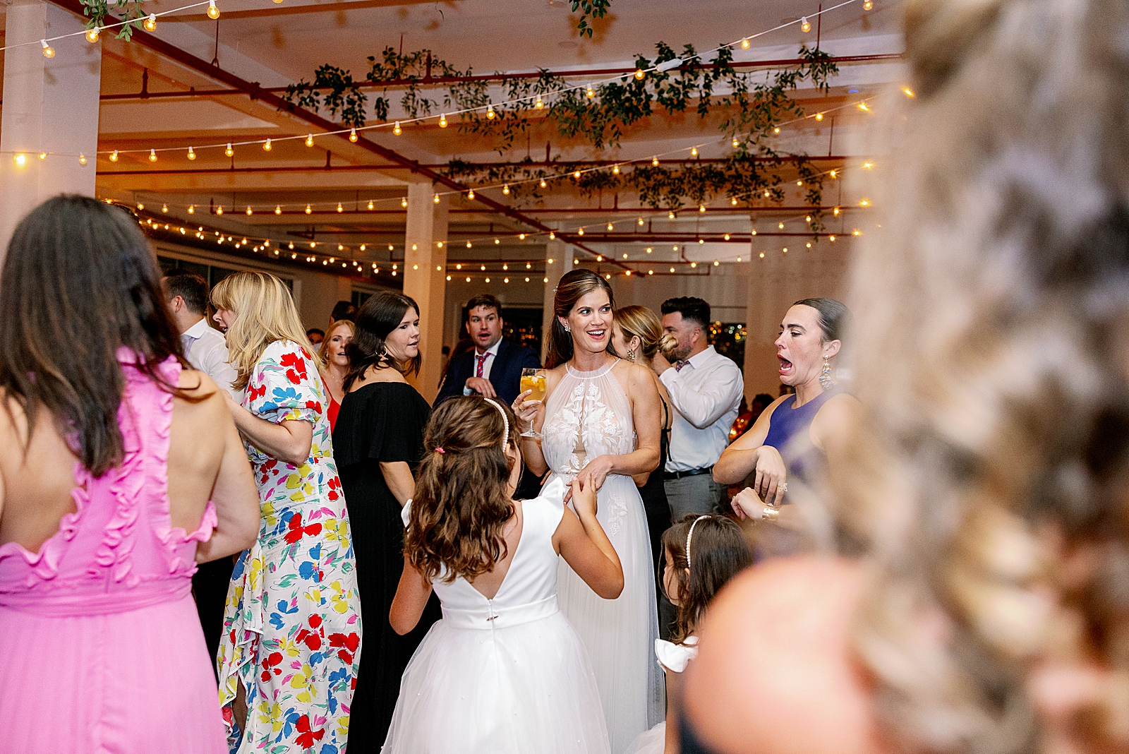 Bride dancing with guests for indoor Reception