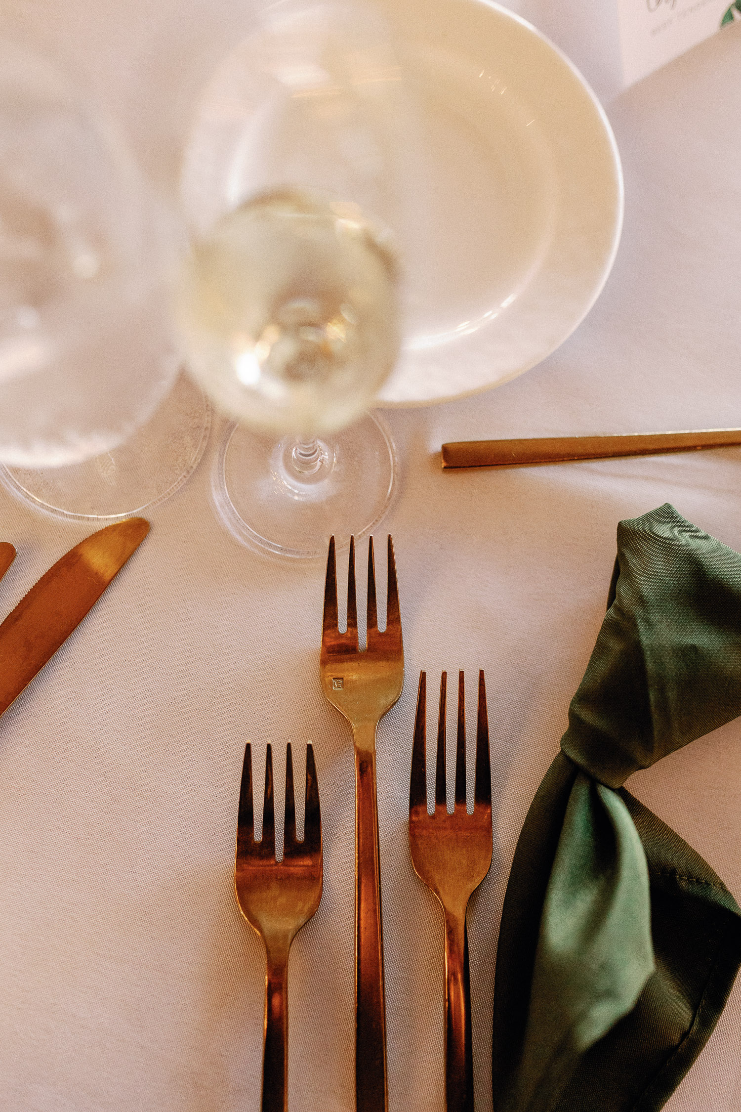 silverware with green and beige linens at the wedding reception baker's cay resort 
