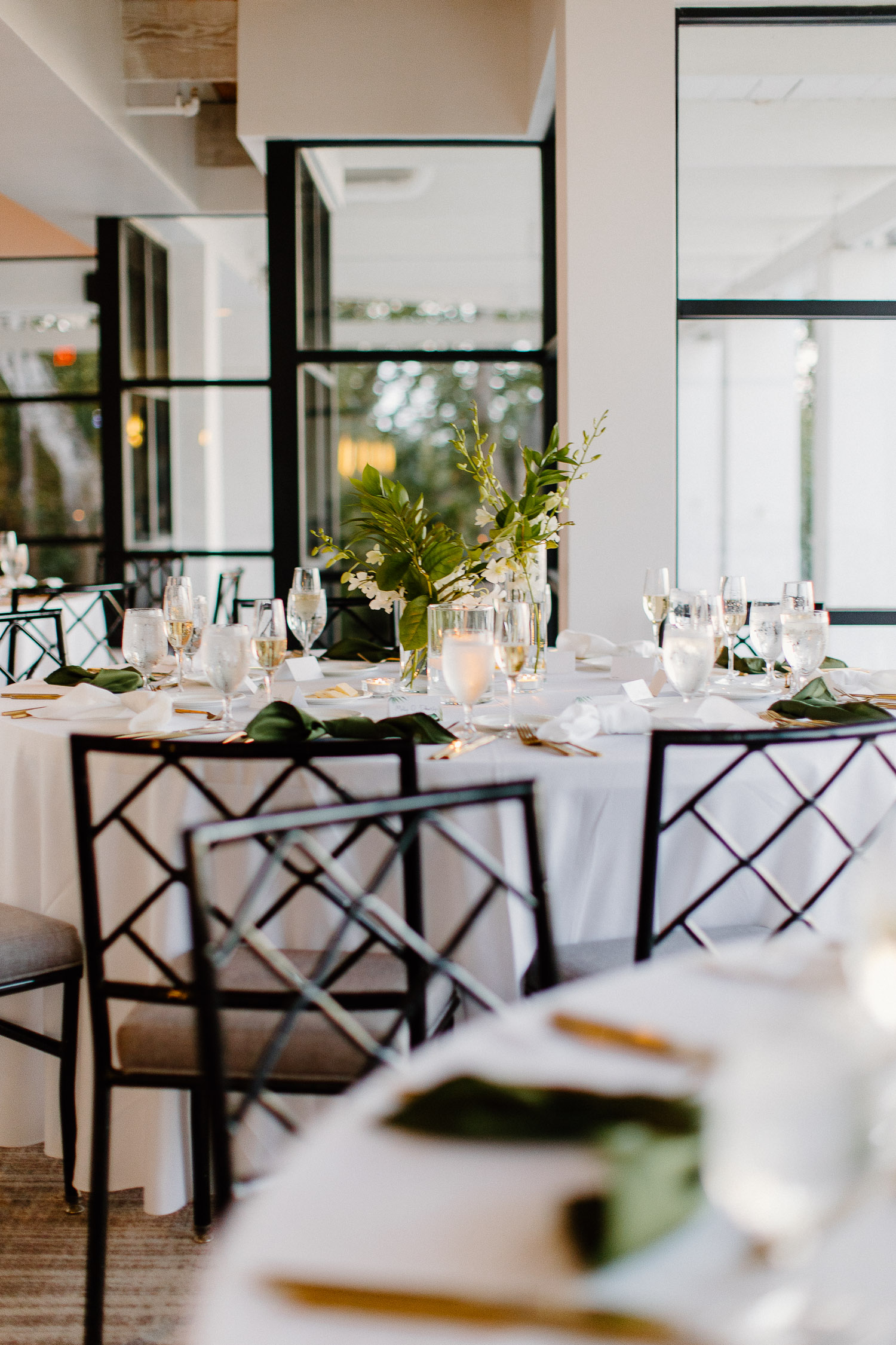 wedding decor wit greenery and white linens 
