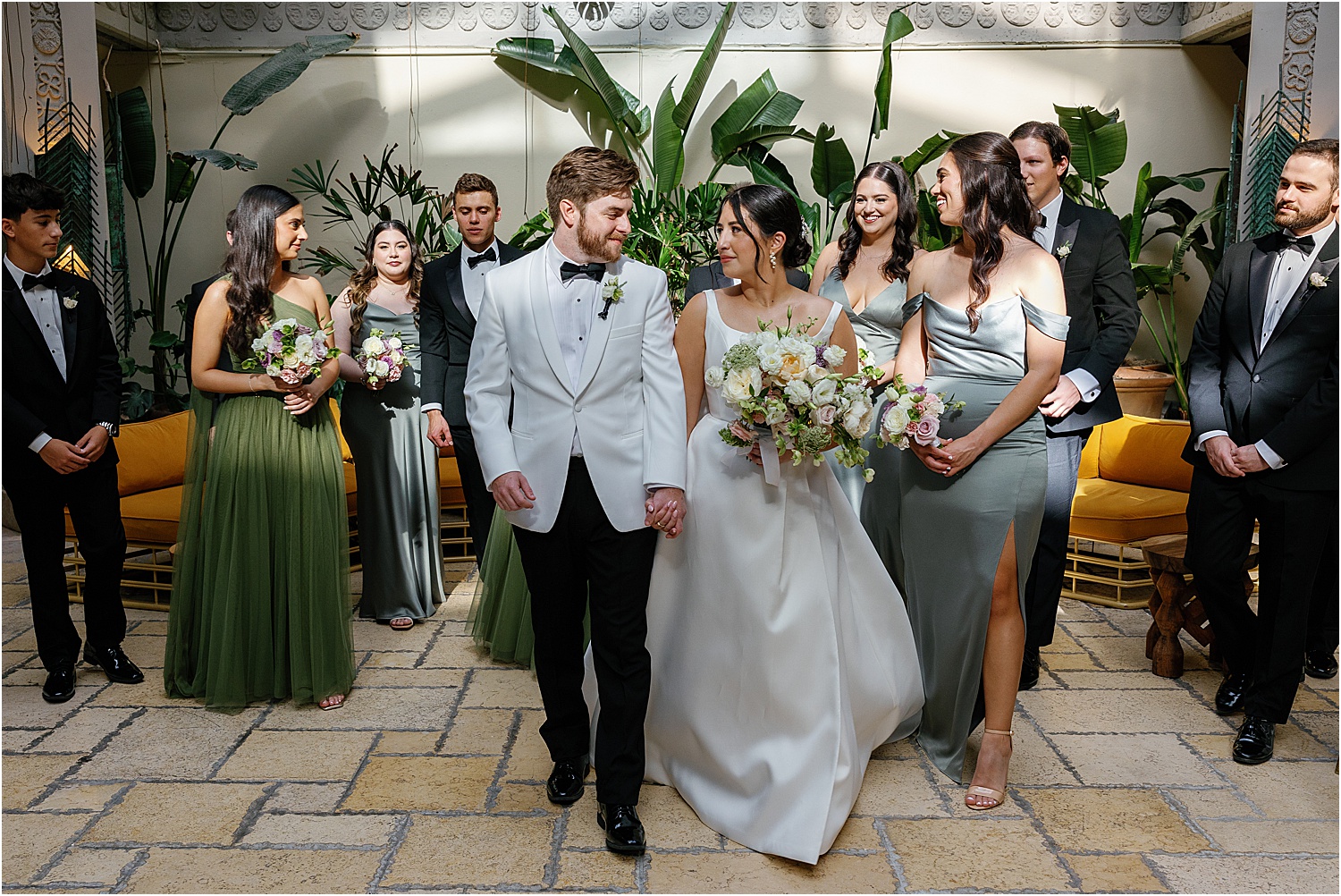 Bridal Party in sage green dresess and balck tuxedos at the Mayfair Hotel & Gardens 