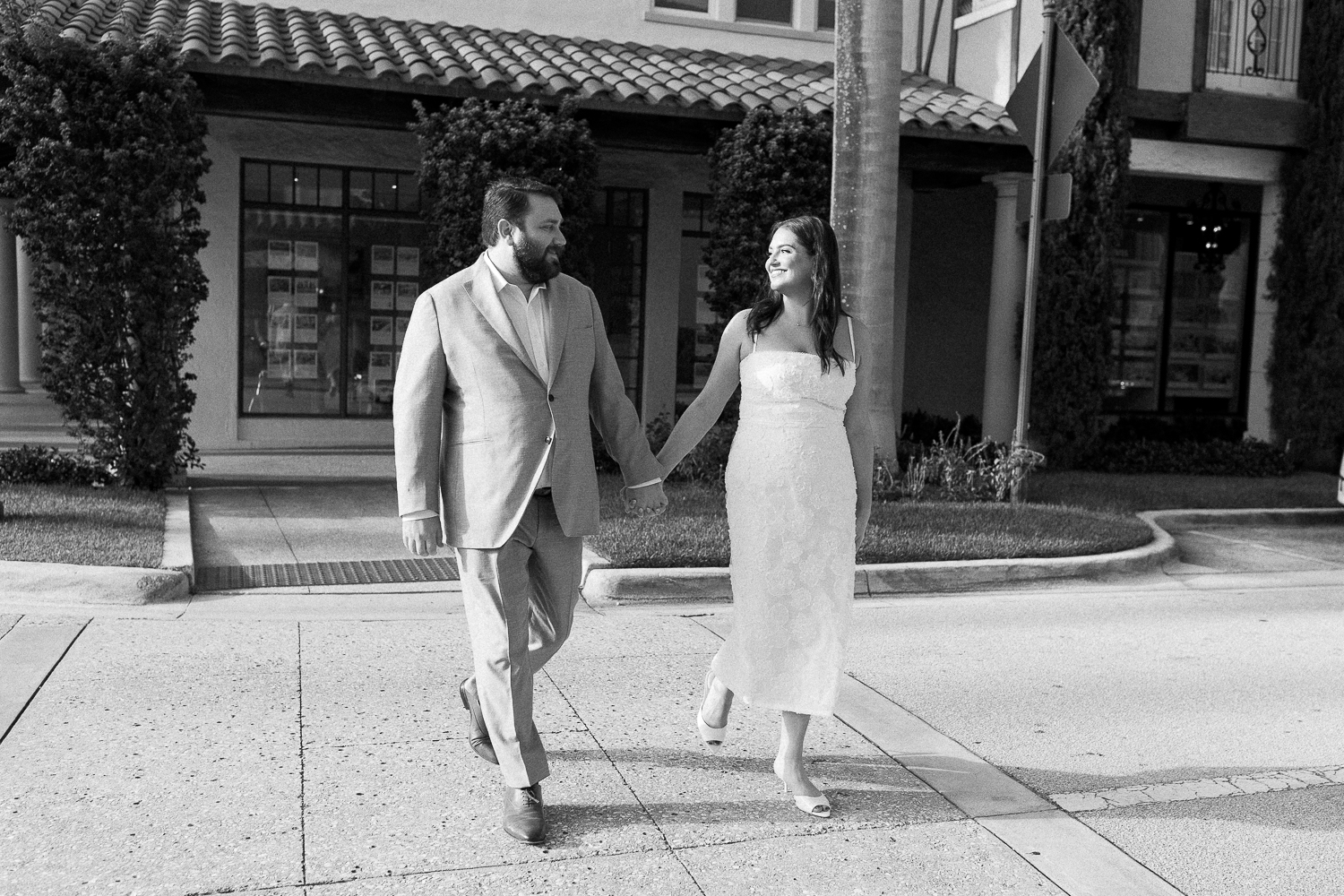 couple crossing the streets on worh ave for engagement photos in west palm beach